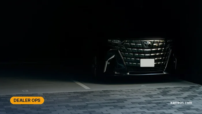 Black Toyota Alphard luxury MPV parked in a dimly lit garage.